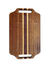 Load image into Gallery viewer, This stunning 11&quot; x 18&quot; cutting board is made of Sapele wood accented with Purpleheart and Red oak wood for a unique, eye-catching look. Its handles provide a comfortable grip for easy lifting, making it the perfect addition to any kitchen.
